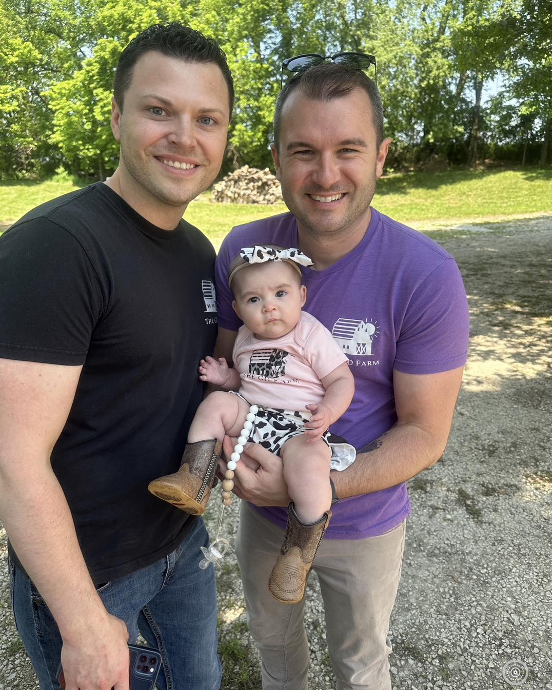 Jacob Garman-Davenport '10, '13 with his husband, Shon, and their daughter